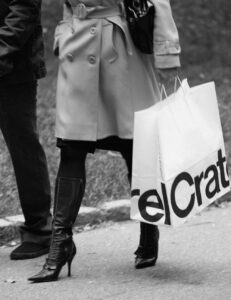 couple on sidewalk with shopping bag
